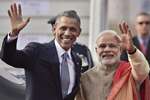 Prime Minister Narendra Modi with visiting US President Barack Obama waves to newsmen upon his  arrival at Air Force station Palam, in New Delhi.